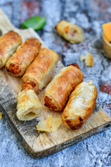  Greek style Mini filo pastry rolls with bacon and cheddar cheese .Home made bakery .Fresh baked  Mini cheese  ,meat and herbs puff pastries