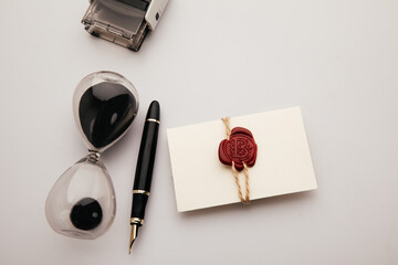 Envelope with wax seal stamp and hourglass