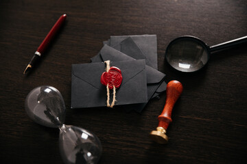 Vintage wax stamp and sealed envelope on dark table