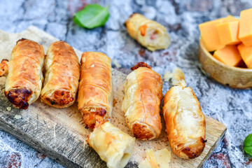  Greek style Mini filo pastry rolls with bacon and cheddar cheese .Home made bakery .Fresh baked  Mini cheese  ,meat and herbs puff pastries