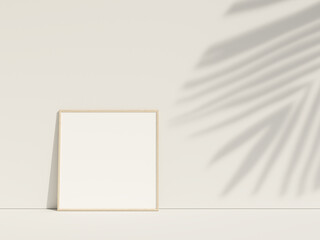 Clean and minimalist front view square wood photo or poster frame mockup leaning against the wall with leaf shadow. 3d rendering.