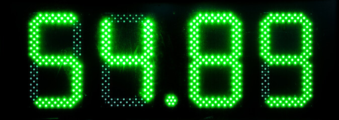 Green LED numbers on the electronic board. The number 54.89 glows through the dirty glass. Possible...
