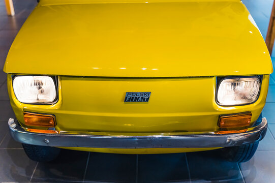 10.20.2022 Warsaw, Poland. Closeup indoor shot of car hood of famous classic warm bright yellow Fiat 126p - Type 126. Rear-engine, four-passenger, city car manufactured in the XX century. High quality