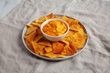 Cheese dip with tortilla chips, side view.