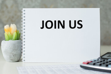 Join Us text on sticky note with a business objects.