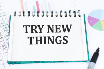 TRY NEW THINGS text on notepad on the background of documents