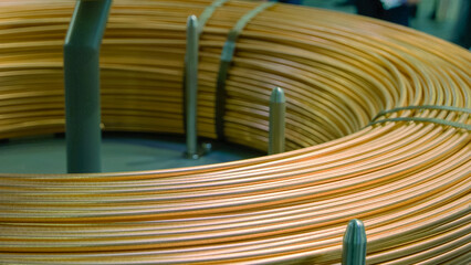 Close-up large copper pancake coil of thick wires. Industrial factory electromagnet.