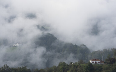 Clouds and fogs over the mountains and farms of Navarra