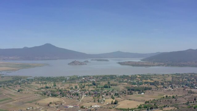 Aerial: scenic view of the islands by the lake and mountains, drone view 