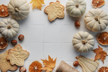 Autumn composition. Frame with pumpkins, dried leaves, cookies and nuts.