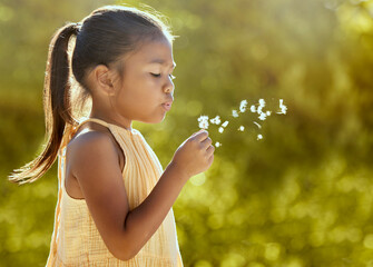 Child, girl or blowing dandelion flower in summer garden, nature park or sustainability environment...