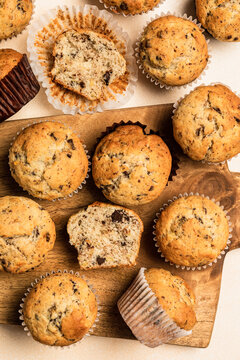 Chocolate Banana Muffins On A Wooden Board, Top View