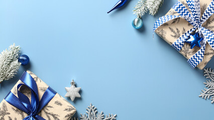 Christmas banner with gift boxes, fir branches, blue and silver decorations on blue background