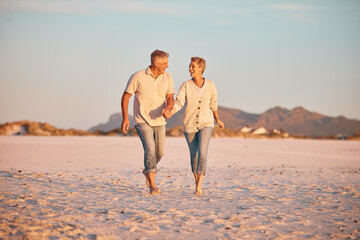 Senior couple on beach, hand holding during retirement and travel, holiday together with love and care outdoor. Elderly, man and woman, romantic walk on the sand, blue sky and summer vacation.