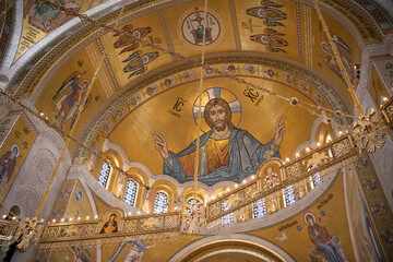 Fototapeta na wymiar Interiors of St. Sava's Church in Belgrade with religious paintings and mosaics on the luxuriously gold decorated walls. Belgrade, Serbia 22.09.2022