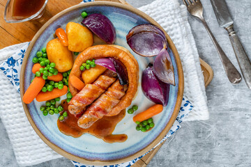 Toad in the hole with Yorkshire pudding, sausages and vegetables