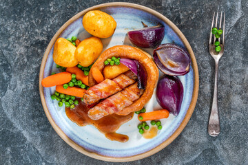 Toad in the hole with Yorkshire pudding, sausages and vegetables