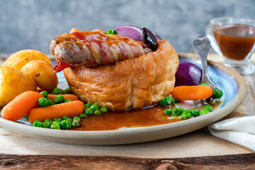 Toad in the hole with Yorkshire pudding, sausages and vegetables