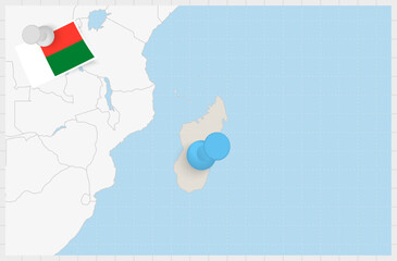 Map of Madagascar with a pinned blue pin. Pinned flag of Madagascar.