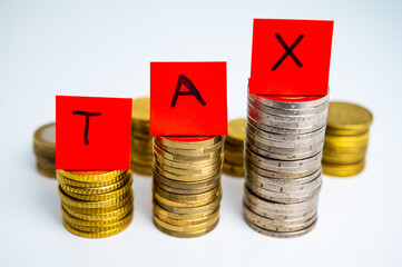 Stacks of coins, and sheets of paper that form the word 