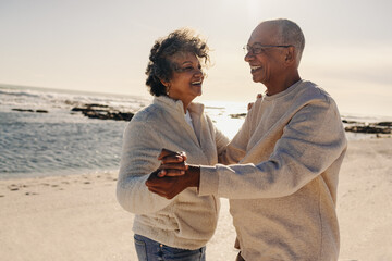 Senior couple dancing together at the beach - Powered by Adobe