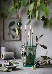 4. Advent. Christmas decorations with light mint color advent candles and eucalyptus leaves....