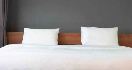 Fototapeta na wymiar white pillows and blanket in minimal hotel bedroom