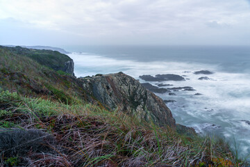 clifftop view looking over a dusk ocean horizon