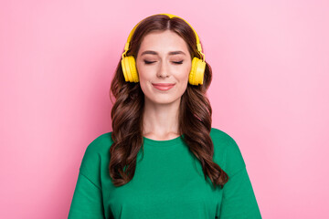 Close up photo satisfied pretty nice lady wear stylish green clothes listening favorite track isolated on pink color background