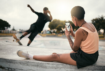Man on skateboard in park, woman photograph skater boyfriend in city on smartphone or urban...
