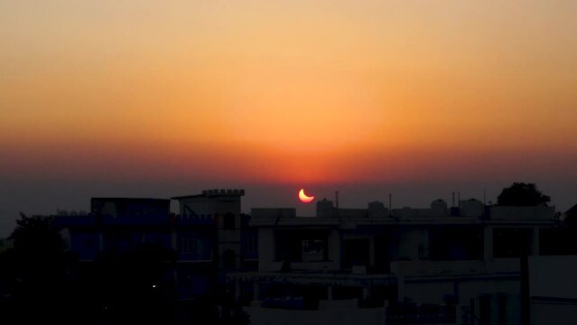 October 25th 2022 Dehradun City, Uttarakhand India. Partial Solar Eclipse in th evening with cityscape.