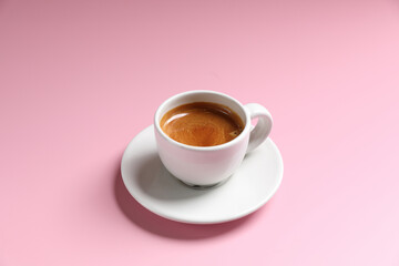 White cup of coffee espresso isolated on pink background