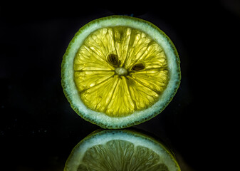 lemon slice with visible texture on a black background