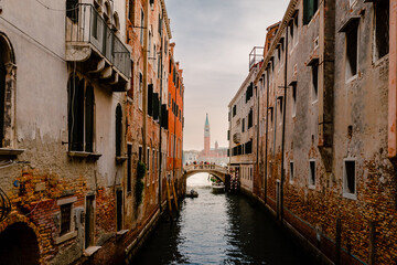Fototapeta na wymiar Venice canal with bridge and bell tower in the background