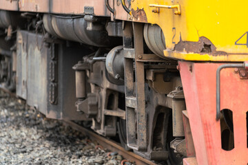Close-up at an ancient model train head cabin and chassis part. Transportation vehicle equipment photo. Selective focus.