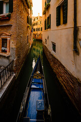 Front end of gondola as it crosses canal in Venice