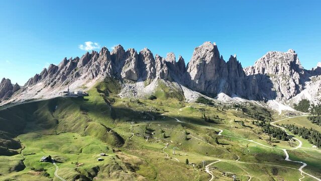 Alp adventure road hair pin twisty in the Dolomites, Italy. Aerial drone overview. Driving route rally cars and traffic passing over a mountain range. Overhead.