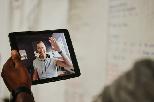 Tablet, Gym And Coach On Video Call With Athlete For Online Fitness Training Or Workout. Exercise, Tech And Personal Trainer Talking To Client On Digital Mobile At Wellness, Sports And Health Studio.