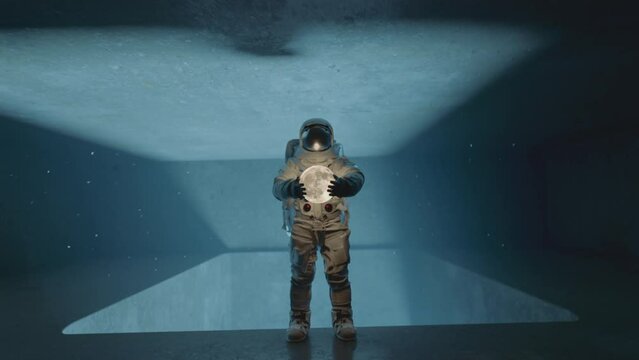 Astronaut in space suit holding the moon, shadows and light moving on the wall. Dark sci-fi interior. 3D animation.