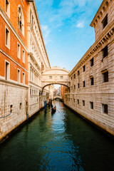 The famous Bridge of Sighs, in Baroque style and built of Istrian stone, with gondola crossing the canal
