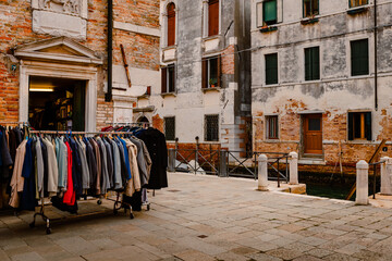 Fototapeta na wymiar Coats for sale from dress store in Venice's historic center
