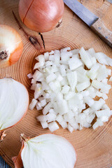 onions cut in half and chopped on old wooden board