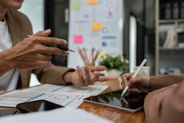 Fund managers team consultation and discuss about analysis Investment stock market by digital tablet