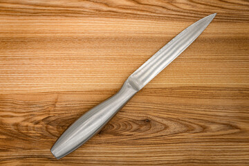 Big kitchen knife lying on a cutting board