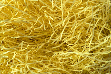 Closeup decorative Shedded yellow color craft paper inside gift box texture background