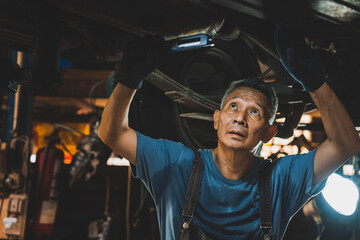 Professional mechanic technician working on the car engine in garage. auto repair service concept, maintenance inspection job to checking vehicle automobile at transport station