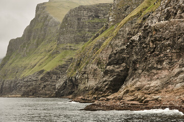 Picturesque green cliffs landscape and atlantic ocean. Faroe islands.