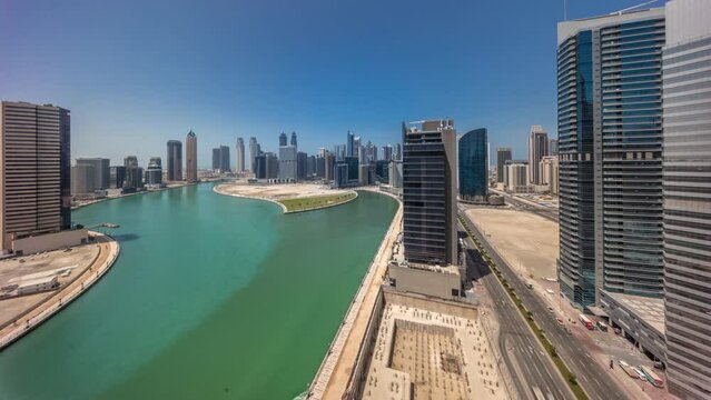 Cityscape skyscrapers of Dubai Business Bay with water canal aerial timelapse with shadows moving fast. Modern skyline with towers and waterfront. A center of international business