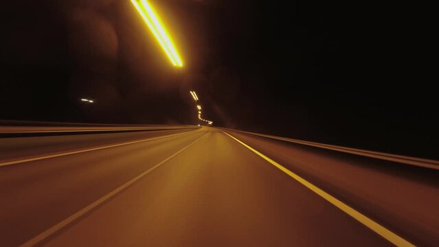 Hypnotic night hyperlapse POV: Driving illuminated highway at night
