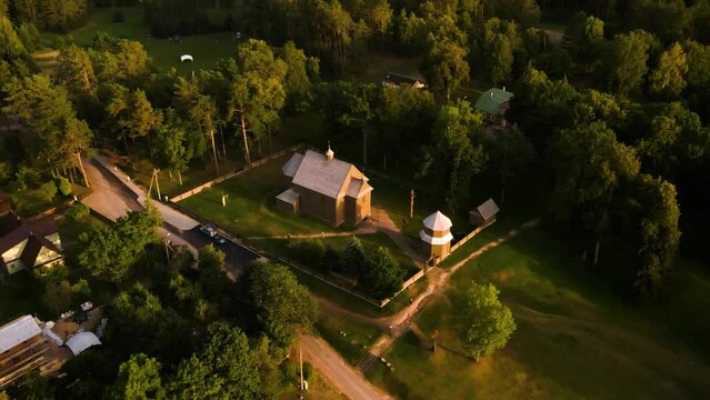 Aerial view of a historic old wooden church in the rural countryside of Salakas, in Paluse vilage, in Lithuania